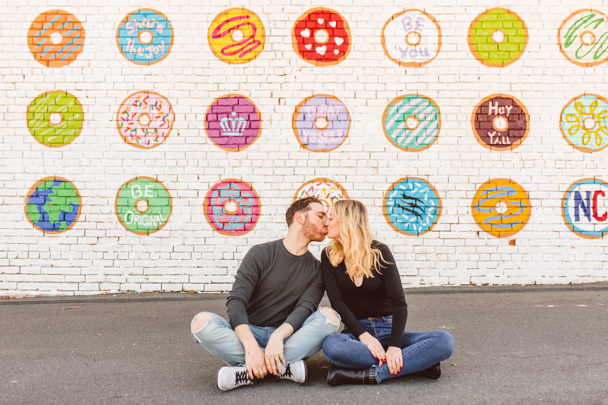Dre Charlotte Influencer posing in front of Donut Wall 6. Donut Wall by Gina Elizabeth Franco at 2116 Hawkins St