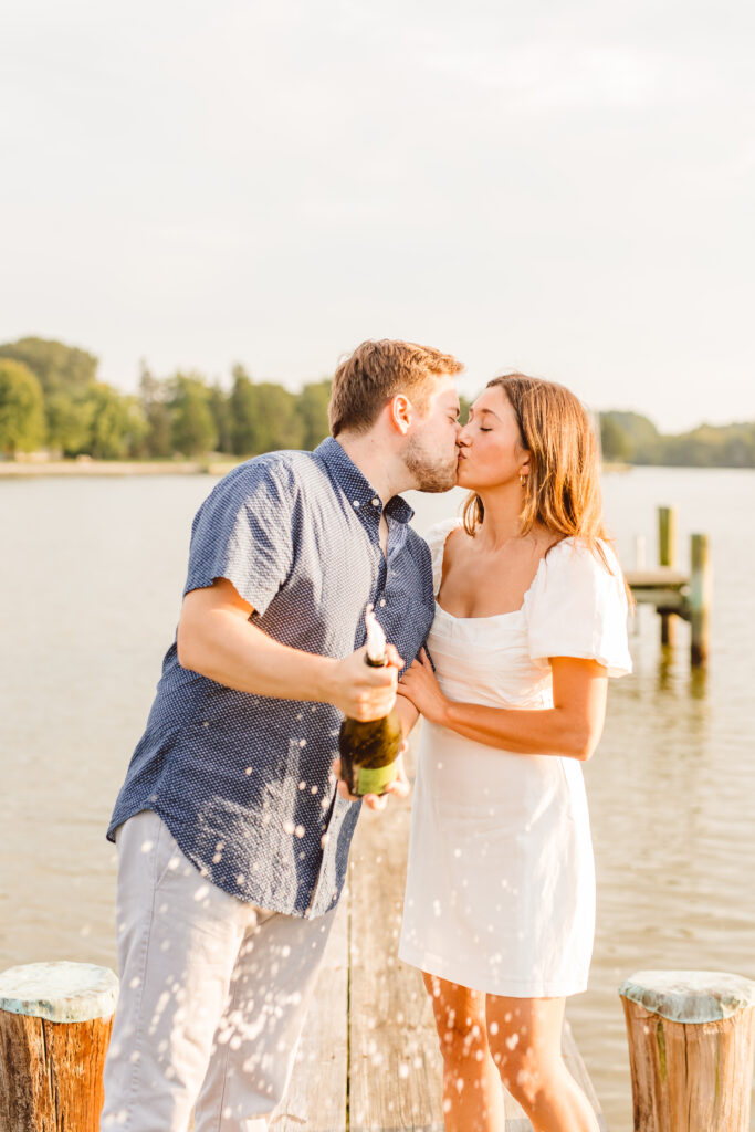 Couple posing for romantic lake engagement photos