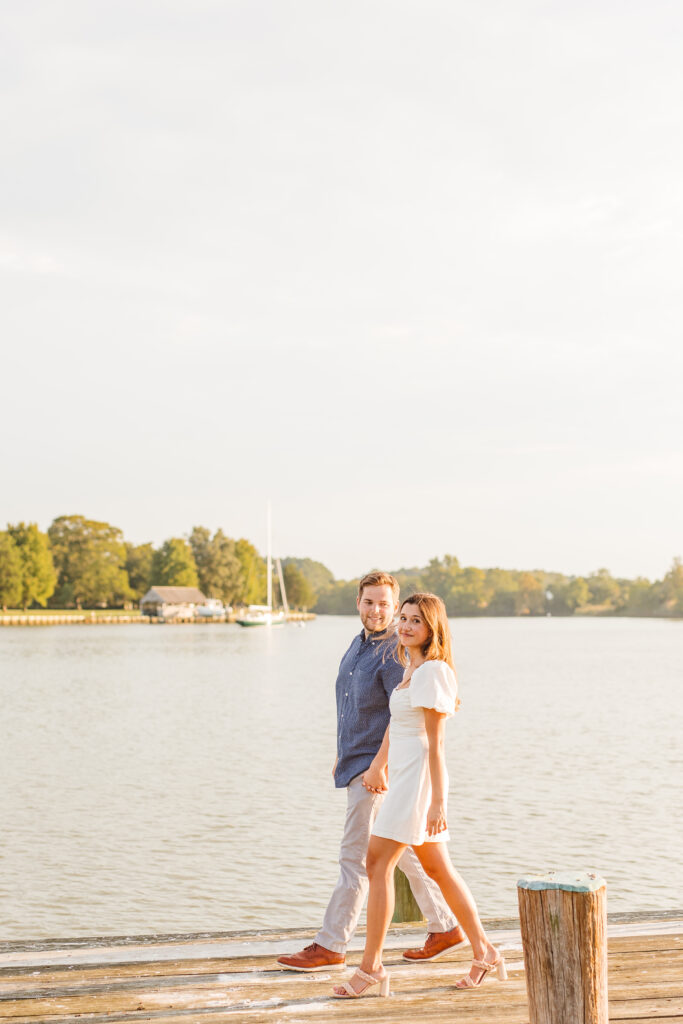 Couple posing for romantic lake engagement photos