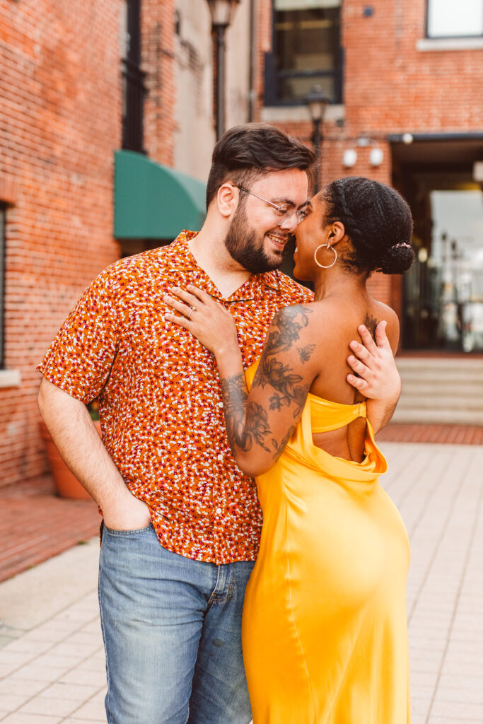 Couple posing for engagement photos in Fells Point in Baltimore Maryland