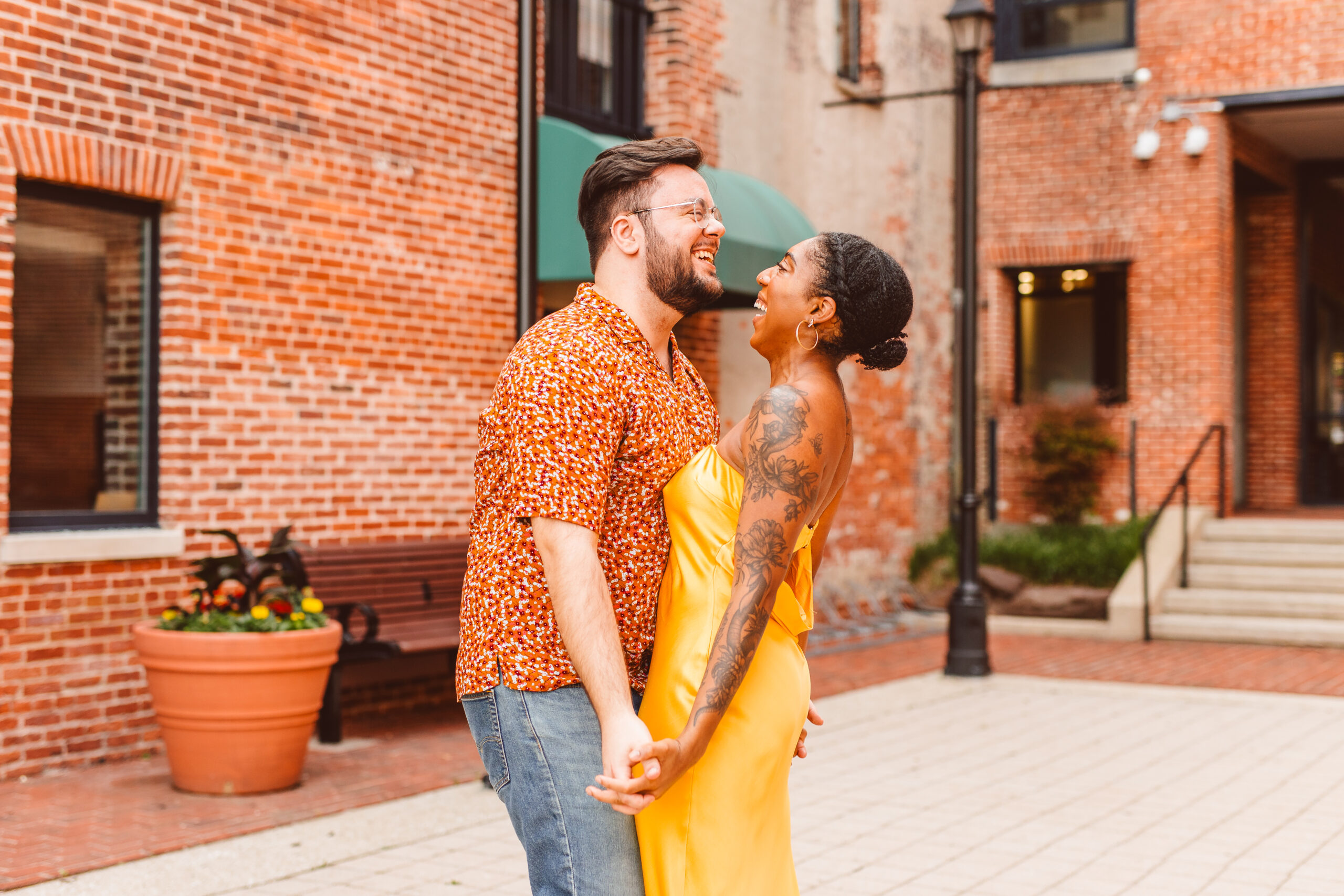 Couple posing for engagement photos in Fells Point in Baltimore Maryland