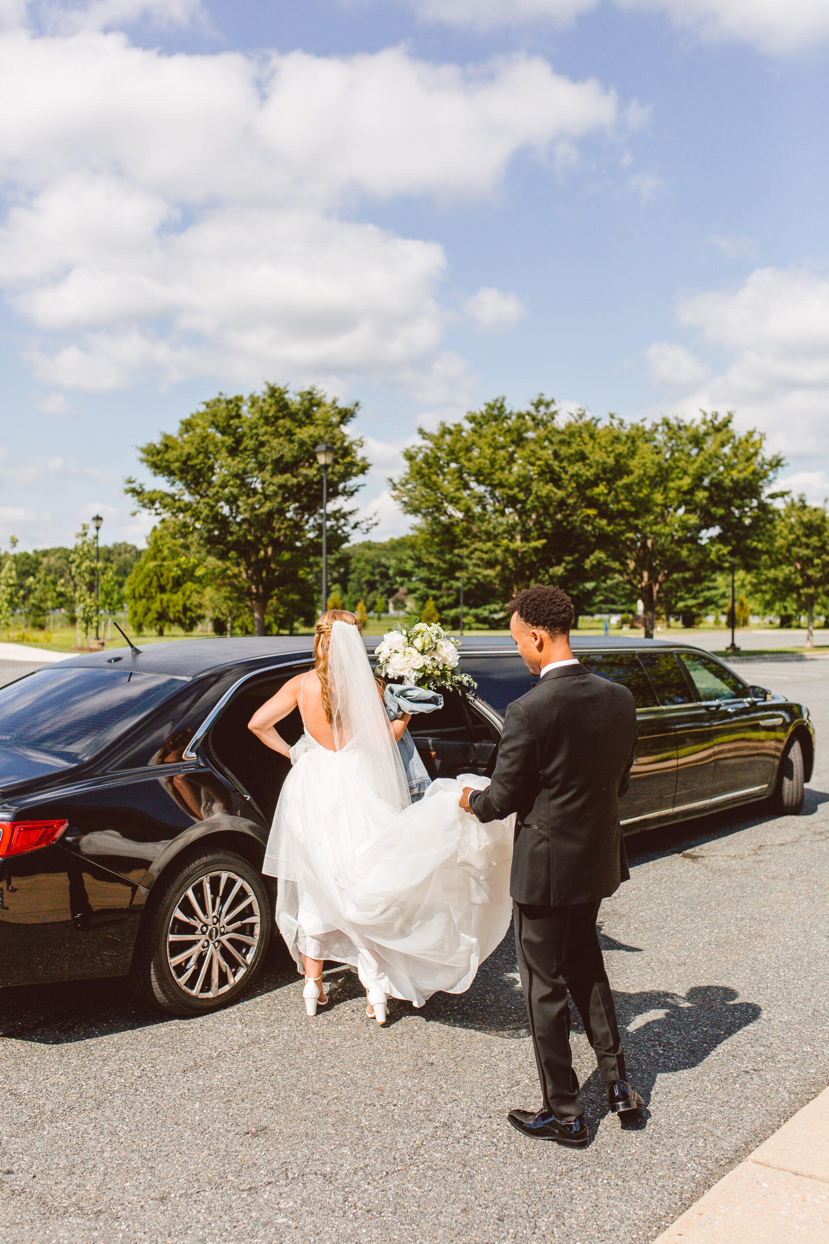 Bride and groom getting into limo