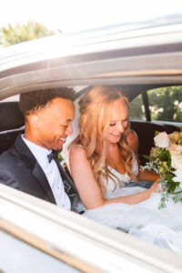 Bride and groom inside of limo