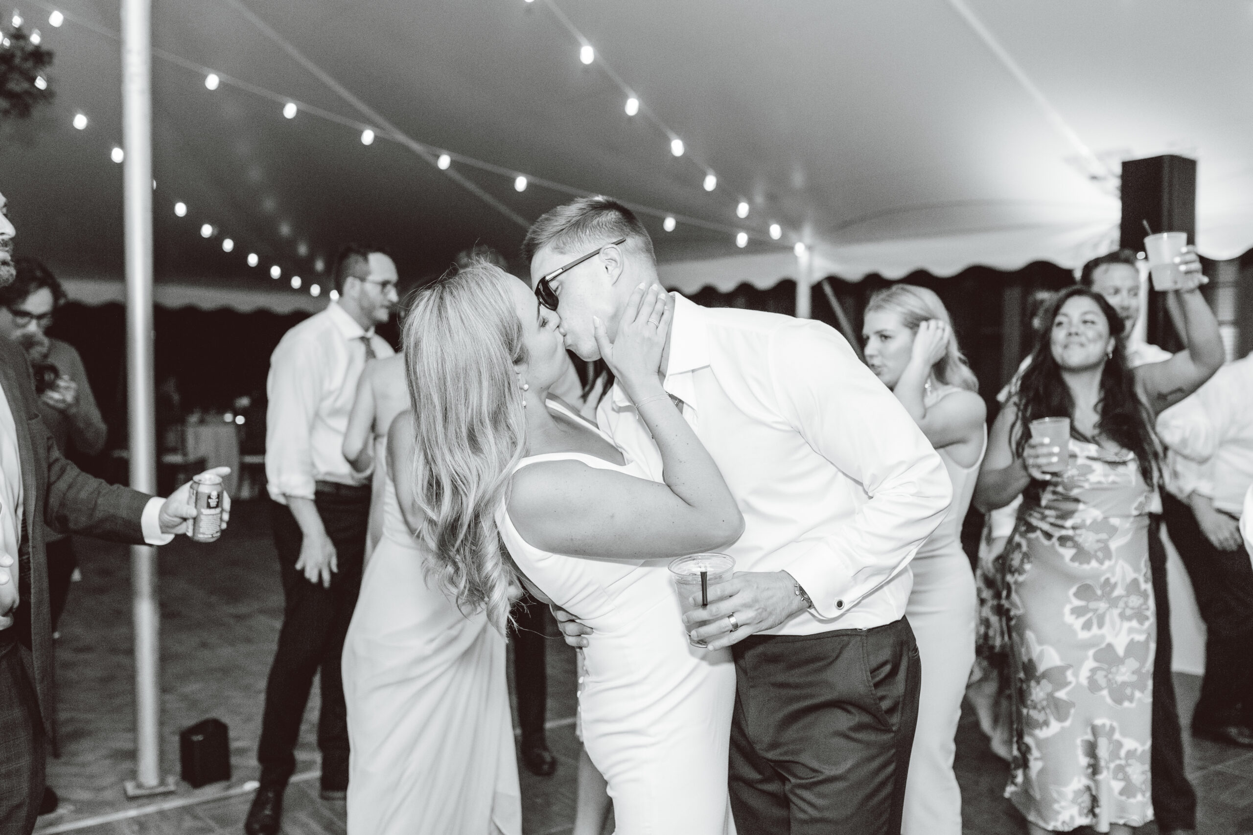 Bride and groom kissing at the end of reception