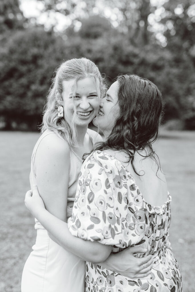 black and white photo of a fiance kissing her fiance on the cheek