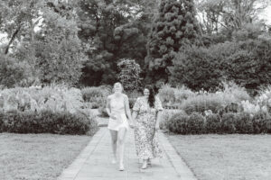 black and white photo of the couple walking on the garden