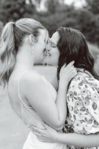 black and white photo the couple kissing each other during their summer engagement session