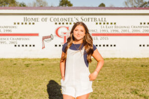 beautiful senior during her photoshoot at her high school softball field