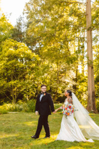 beautiful couple walking on the garden before their ceremony