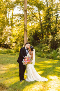 portrait of the bride and groom kissing at their garden wedding