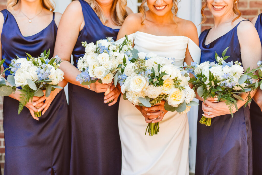 close up shot of the bride and bridesmaids with their bouquets