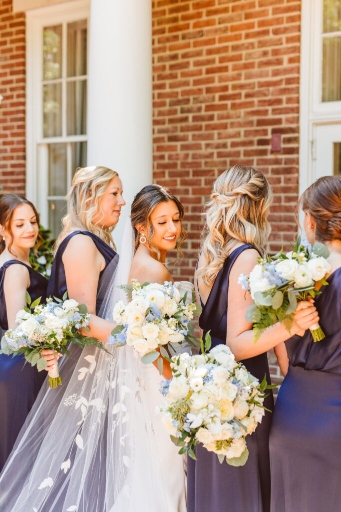 bridesmaids wearing a navy blue gown