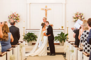 bride and groom kissing after their elegant wedding ceremony
