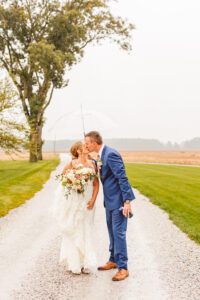 bride and groom kissing at their Intimate Rainy Wedding Day