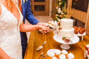 couple cutting their Intimate Rainy Wedding Day cake