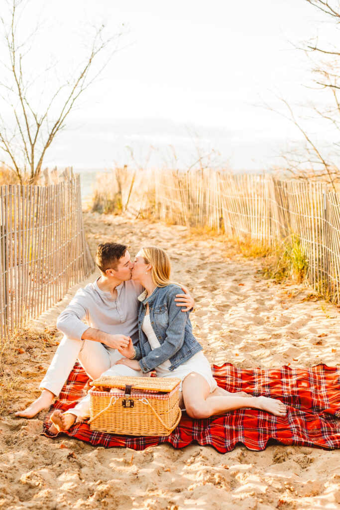 couple kissing during their picnic