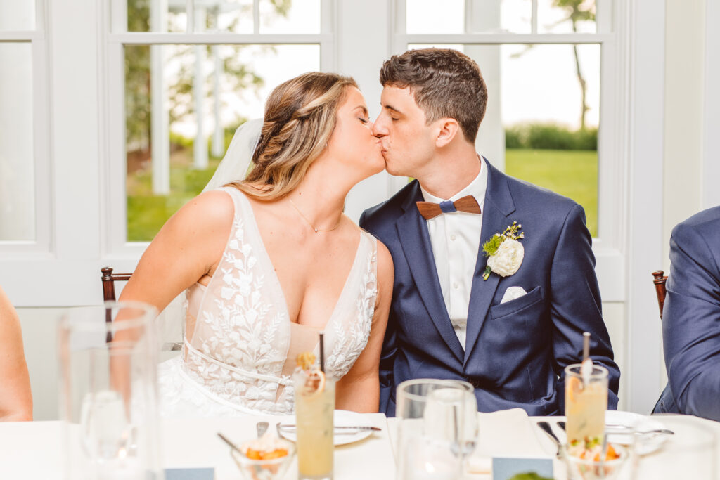 bride and groom kissing at their wedding reception