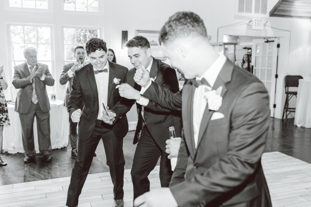 groom and his friends dancing - elegant bayside wedding