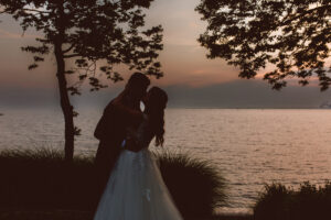 couple kissing during sunset - elegant bayside wedding