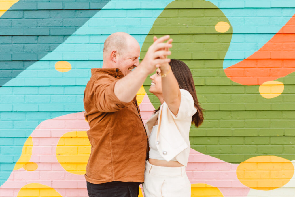 happy couple dancing during their photoshoot - romantic & vibrant engagement session