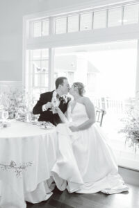 cute couple kissing at their wedding reception