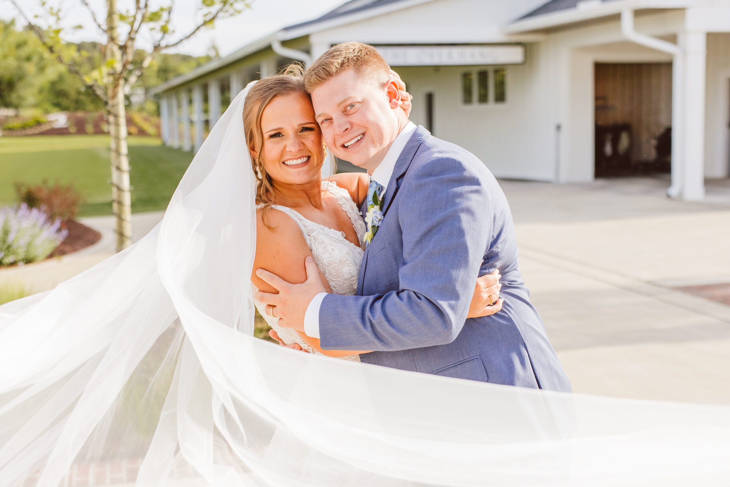 Couple smiling at the camera during their bridal portraits