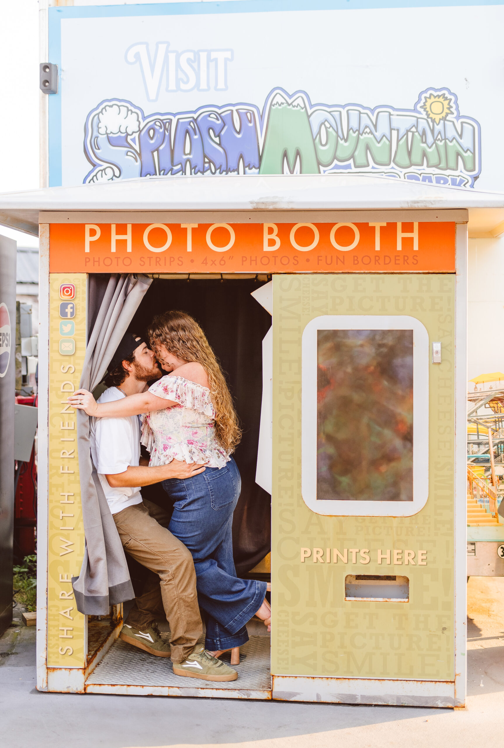 Newly engaged, couple kissing during their photo session
