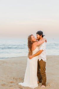 Couple dancing at the beach during their photoshoot