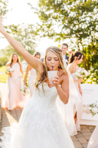 beautiful picture of the bride celebrating her ceremony with a drink