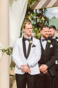 groom watching the bride walk down the aisle