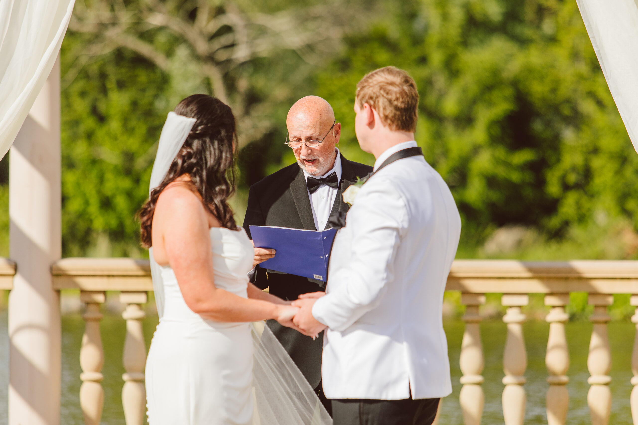 bride and groom holding hands during their ceremony