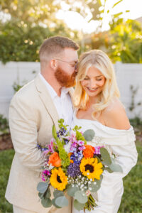 groom kissing the bride on the cheek