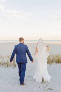 couple walking around the beach after their wedding ceremony