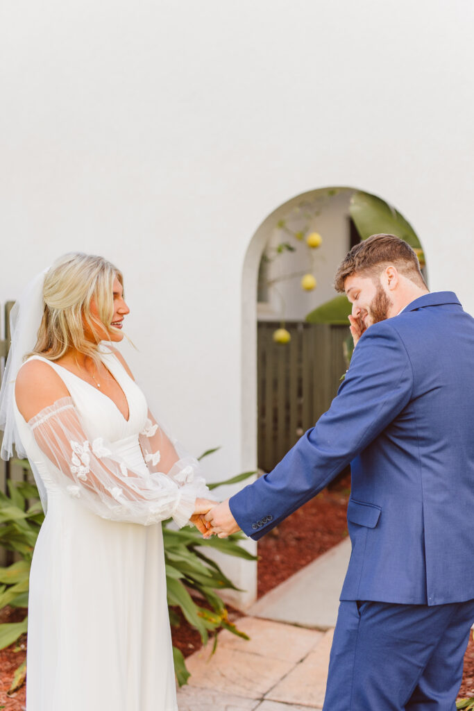 cute picture of the bride and groom emotional during their first look