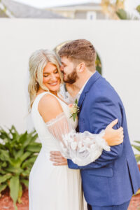 groom kissing the bride on the cheek