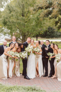 cute picture of the bride and groom with their bridal parties