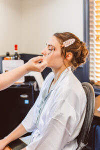 bride getting her makeup done for her ceremony