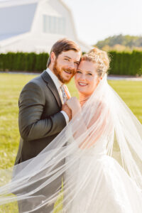 newlyweds smiling at the camera during their photoshoot