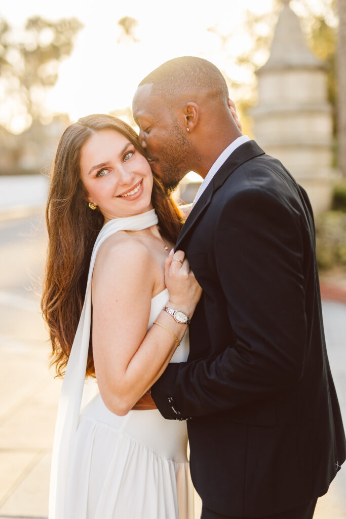 fiance kissig his fiance on the cheek