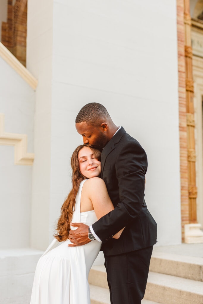 fiance kissing his fiance on the forehead