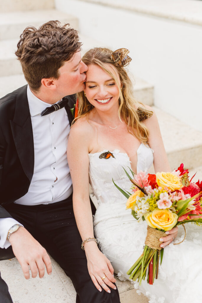 Grooming kissing the bride on the forehead