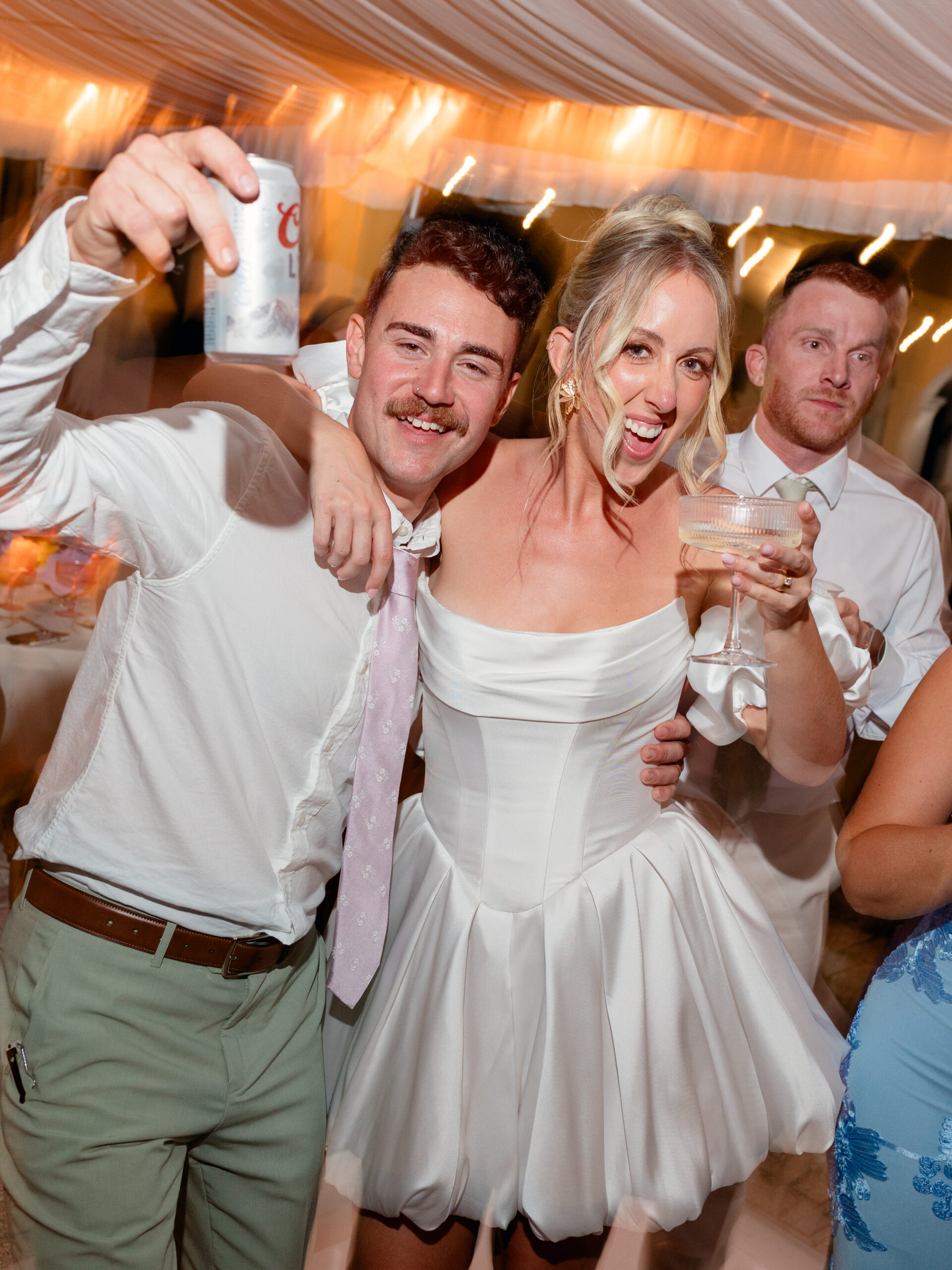 fun portrait of the newlyweds at their dream wedding reception party