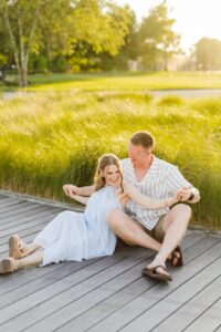 Couple smiling and hugging in downtown Nantucket during their engagement session