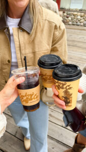 Close-up of three Cowboy Coffee Co. cups branded with the Jackson Hole coffee shop's logo